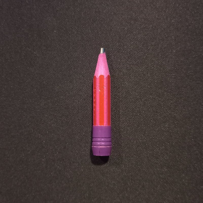 a very short pink and purple pencil with stripes.