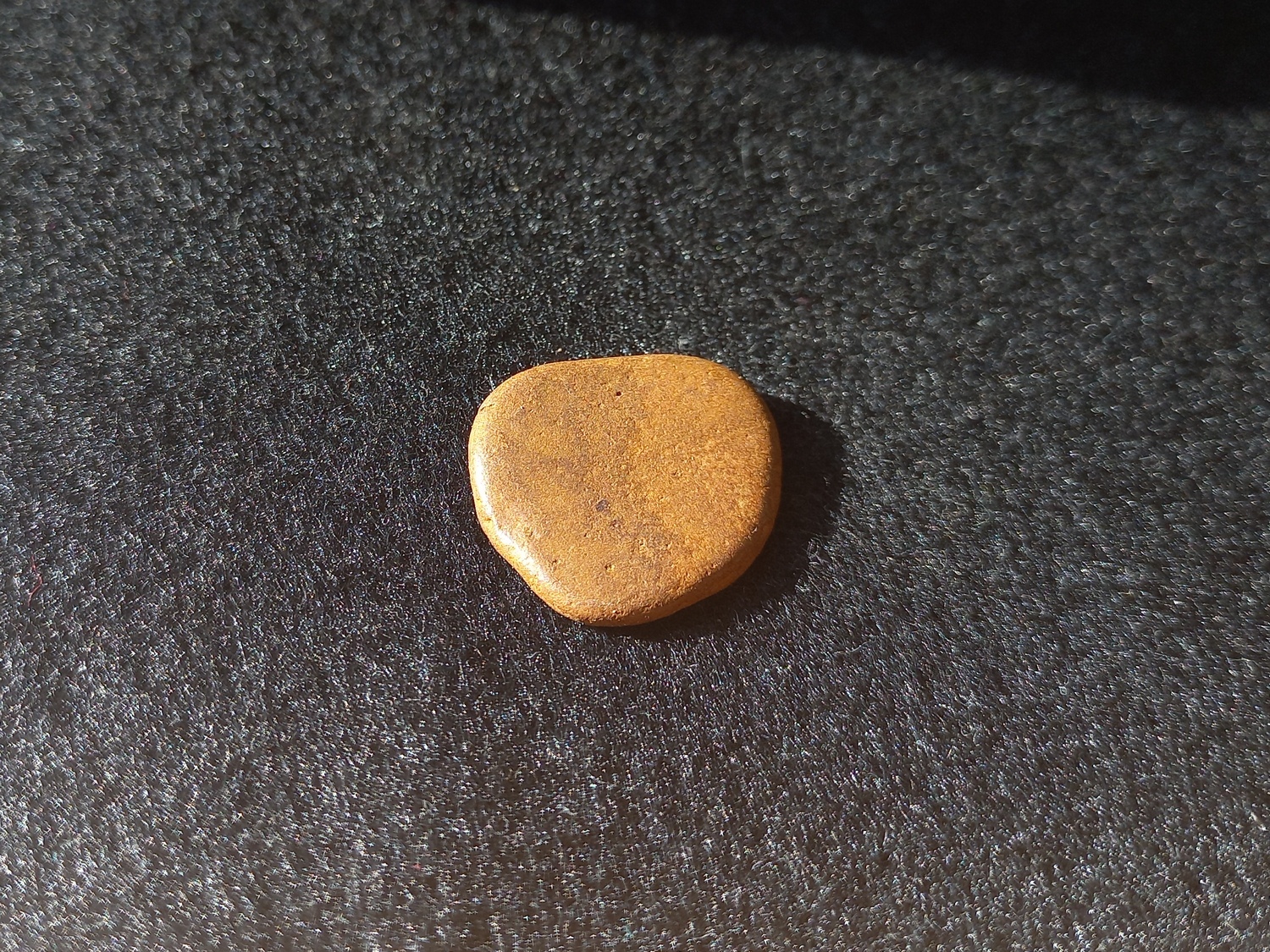 very flat, circular and smooth rock